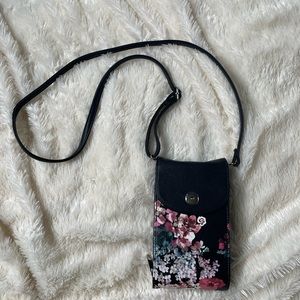 Crossbody bag with black floral design and RFID protected card holders